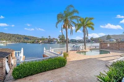 Stunning 4BR Holiday Home with Water Views & Pool Hotels near Barrenjoey Lighthouse