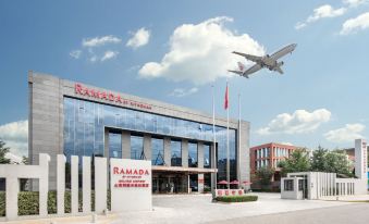 "A large building displaying the words ""Welcome to China"" and an accompanying image indicating the distance" at Ramada by Wyndham Beijing Airport