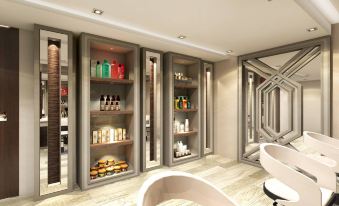 a modern bathroom with a bathtub and a row of shelves filled with various toiletries at Rizal Park Hotel