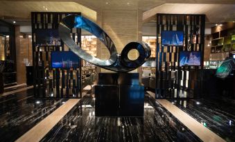 The lobby features an art deco-style black and white sculpture as its centerpiece at Pullman Shanghai Jing An