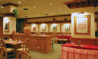 a well - decorated restaurant with various dining tables and chairs , creating a warm and inviting atmosphere at Rimpao Hotel