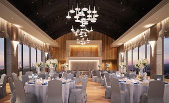 a large dining room with tables and chairs set up for a formal event , possibly a wedding reception at Rattanachol Hotel