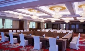 A spacious room is set up with rows of long tables for an event or function at Jinghu Hotel