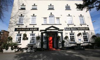 "a white building with a red door and the words "" brewers arms old mill brew "" written on it" at The Brewers Arms