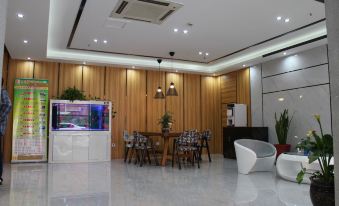 There is a room in the office foyer that has tables and chairs next to the living area at Super 8 Hotel (Shanghai Pudong Airport Chenyang Road)