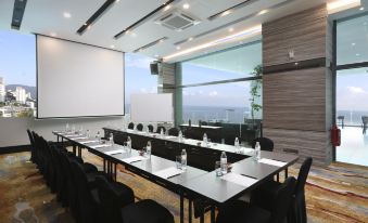 a conference room set up for a meeting , with chairs arranged in rows and a whiteboard on the wall at Hompton Hotel by The Beach