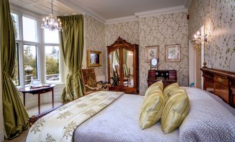 a luxurious bedroom with a large bed , multiple pillows , and a mirror on the wall at Pale Hall Hotel