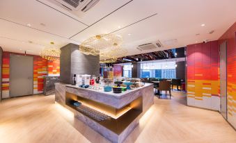 a modern restaurant with a large dining area and a kitchen area , featuring various dishes and utensils on display at Ibis Styles Hotel