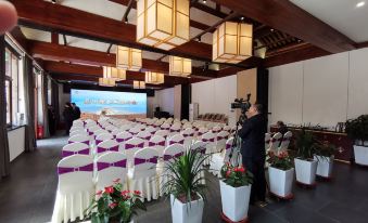 The ballroom is set up with tables and chairs for a large event at Mutianyu Great Wall Hotel