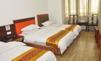 The bedroom features double beds and hardwood floors that match the color scheme of the other rooms at Tongtong Hotel