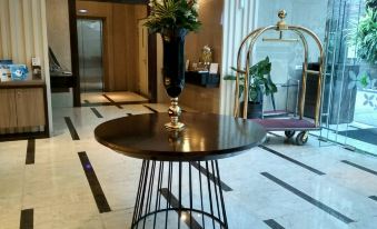 a modern dining room with a round dining table , chairs , and a potted plant on the floor at Best Western Premier la Grande Hotel