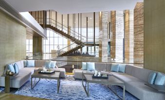 a spacious room with contemporary furnishings and a floor-to-ceiling window that provides an open view at Hangzhou Marriott Hotel Qianjiang