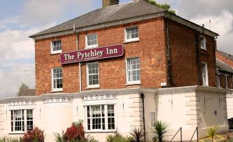 "a brick building with a sign that reads "" the ivy inn "" prominently displayed on the front of the building" at The Pytchley Inn