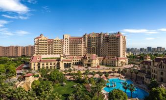 The hotel is a multi-story building with an outdoor pool located in the front at Radisson Blu Forest Manor Shanghai Hongqiao