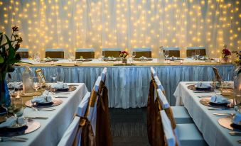 a long dining table set up for a formal event , with multiple chairs arranged around it at Club Tropical Resort Darwin