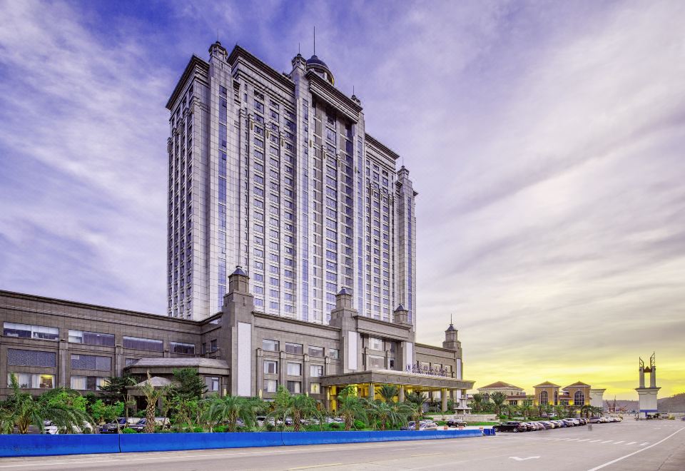 The tall building offers a scenic outside view of the skyline at Glory Charm Hotel