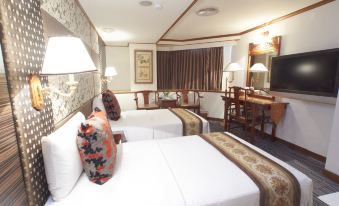 a hotel room with two beds , a dining table , and a tv , decorated in a modern style at Han She Business Hotel