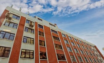 In front of a large building with numerous windows on the side, there is an office block at Jinjiang Metropolo Shanghai Xintiandi Hotel