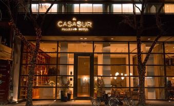 "the exterior of a restaurant called casasur with a sign that reads "" cassuur village "" in front of it" at Kos Pilar Hotel