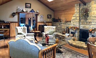 a cozy living room with wooden furniture , including a couch , chairs , and a coffee table at Walnut Waters Bed & Breakfast