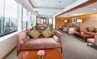 large room with couches and chairs in the living area, providing a view of the outside through the windows at Jin Jiang Tower