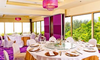 A room with large windows and tables set for 10 in the dining area, providing a view at Grand Coloane Resort Macau