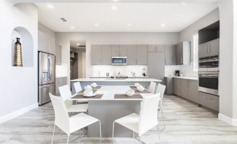 a modern kitchen with a dining table and chairs , as well as a refrigerator and microwave at Balmoral Resort Florida
