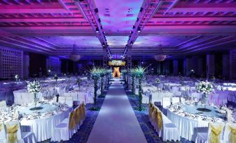 A ballroom is arranged for an event, with tables and chairs placed in the center at Dong Fang Hotel