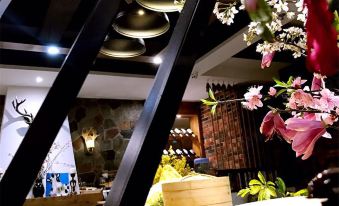 a modern cafe with black metal beams , wooden beams , and flowers , as well as some food items on display at Z Hotel