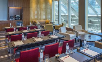 a conference room set up for a meeting , with several chairs arranged in a row and a tv mounted on the wall at Grand Hyatt Manila