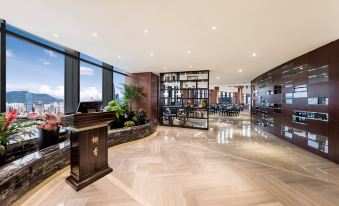 The photo showcases a modern living room in an apartment with large windows and a view from the top at Shenzhen Huaqiang Plaza hotel (Huaqiangbei Metro Station)
