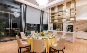 The spacious room includes an open concept kitchen and dining area with a six-person table at SKYBIRD Hotel (Shanghai Hongqiao Airport)