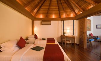 The bedroom has two beds and an open-air area for relaxation at Aureum Palace Hotel & Resort Ngapali