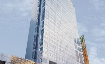 A large building with a visible exterior and the hotel's name displayed on the front at Harbour Plaza North Point