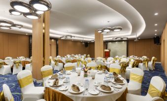 a large dining room filled with tables and chairs , ready for a formal event or a banquet at Grand Palace Hotel