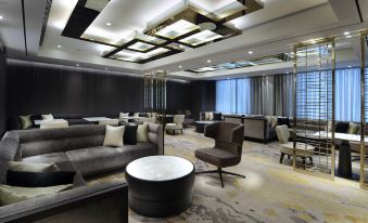 a modern hotel lobby with various seating arrangements , including couches , chairs , and a coffee table at Caesar Park Hotel Banqiao
