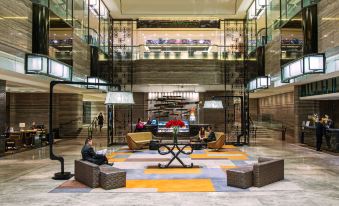 The lobby at Person's in Paris features multiple large tables and chairs at Royal Plaza Hotel