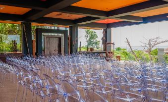a large group of empty chairs are arranged in a room with an orange ceiling at Hotel Las Islas