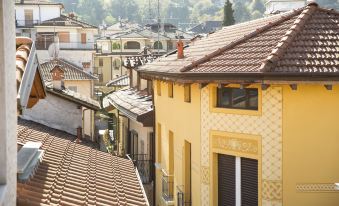 a view of a city street with buildings and rooftops , including a yellow house with tile roof at PRIMAVERA