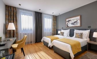 a modern hotel room with two beds , a desk , and a window , decorated in gray and yellow colors at Sia Split Hotel