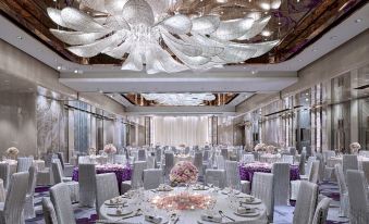 The ballroom is decorated and set up with tables and chairs for an event at Royal Plaza Hotel