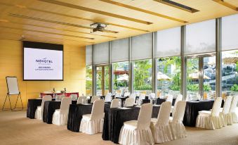 a large event room with tables and chairs arranged facing the front at Novotel Citygate Hong Kong