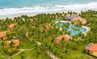 a large resort with multiple swimming pools and palm trees is shown from an aerial view at Pandanus Resort