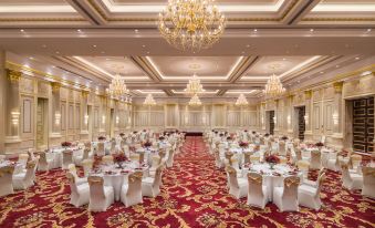 The ballroom is decorated and set up with tables and chairs for an event at Radisson Blu Forest Manor Shanghai Hongqiao