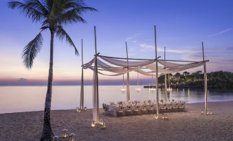 a beach scene with a large white tent and a table set up for an event at Shangri-La Boracay