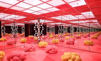 a room filled with pink and yellow bean bag chairs , creating a unique and eye - catching design at Just Sleep Ximending