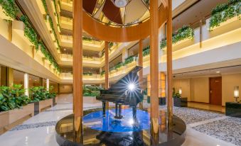 The lobby features a spacious pool and fountain, along with access to other rooms at Metropark Hotel Shenzhen