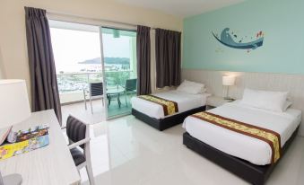 a modern hotel room with two beds , a balcony , and a view of the ocean at Marina Island Pangkor Resort & Hotel
