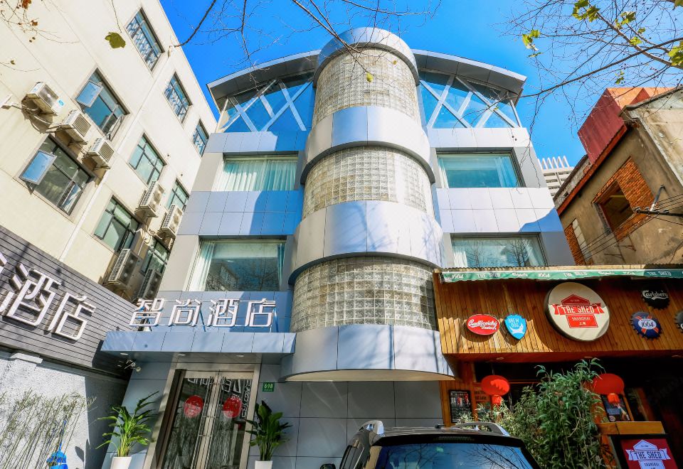 The hotel's front entrance showcases an intriguing architectural feature on its facade, along with additional decorative elements at Zhotels (Shanghai West Nanjing Road Westgate Mall)