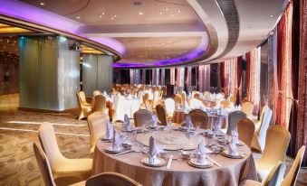A spacious room is arranged with tables and chairs for a hotel or conference event at Central Hotel Shanghai